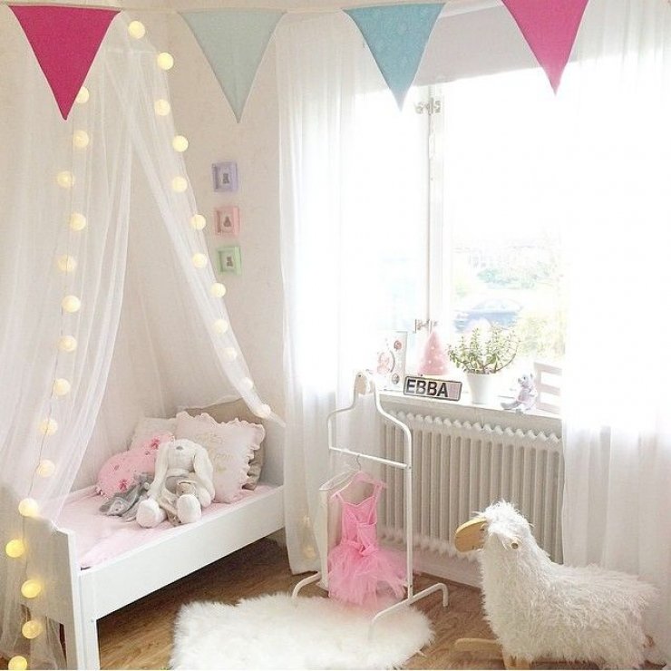 soft pink and light garland in a girls room