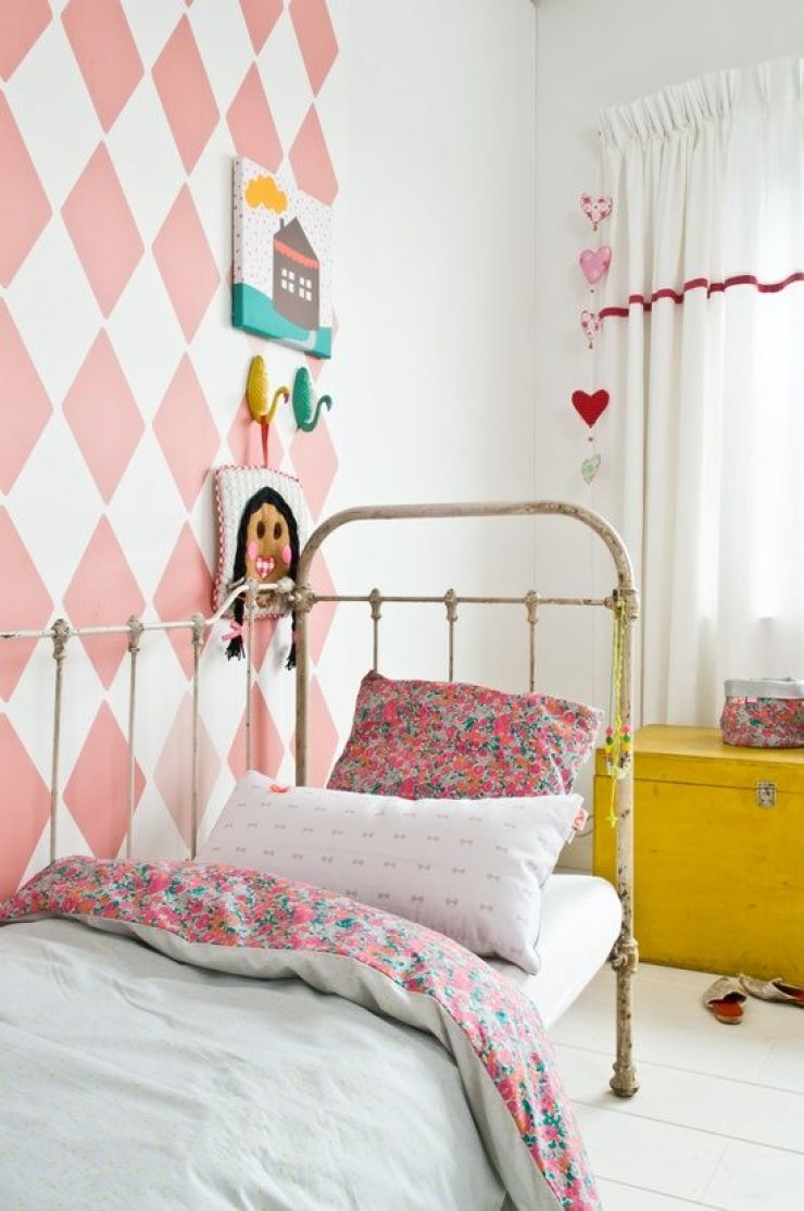 pink geometric wall in a girls room