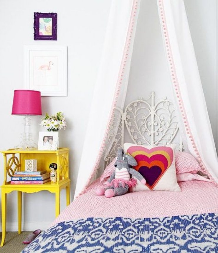yellow nightstand in a girls room